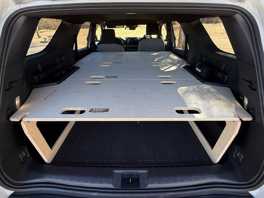 Trunk of a vehicle with a flatbed platform inside